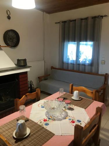 a dining room with a table and a couch at Gourgiana Apartments in Andritsaina
