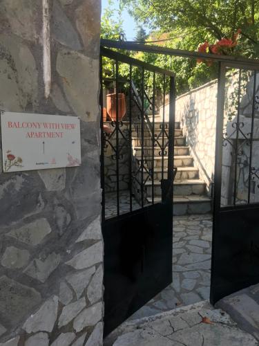 a door to a building with a sign on it at Gourgiana Apartments in Andritsaina