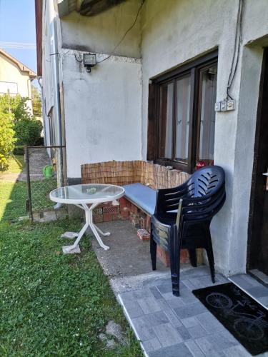a table and chairs sitting outside of a house at Appartement Drava 1 in Donja Dubrava