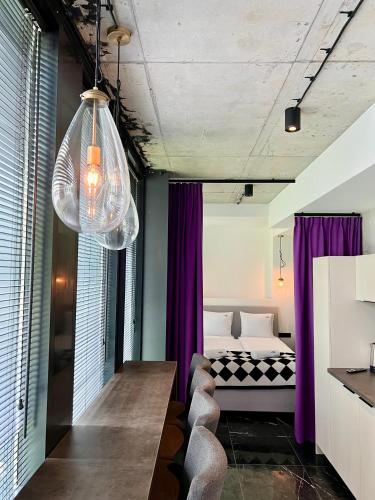a bedroom with purple curtains and a bed in a room at NEON APARTMENTS in Sopot