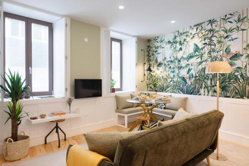a living room with a couch and a table at Away to Enjoy Apartment - hapiness has a place in Porto