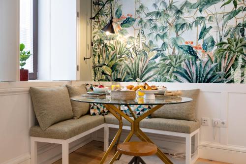 a table with fruit on it next to a couch at Away to Enjoy Apartment - hapiness has a place in Porto