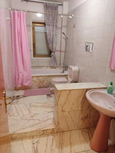 y baño con lavabo, aseo y bañera. en Casa Helios, en Lentini