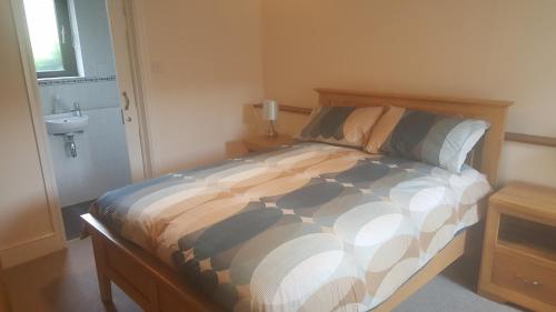 a bedroom with a bed and a sink at The Rocks in Westward Ho