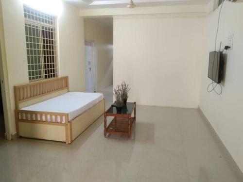 ein Schlafzimmer mit einem Bett und einem TV in einem Zimmer in der Unterkunft Simhagiri Holiday Inn in Visakhapatnam