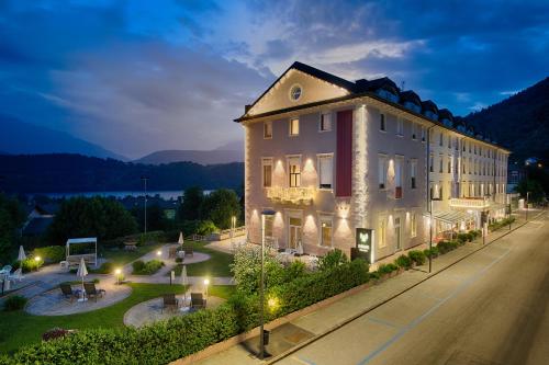 a large building on the side of a street at night at Bellavista Relax Hotel in Levico Terme