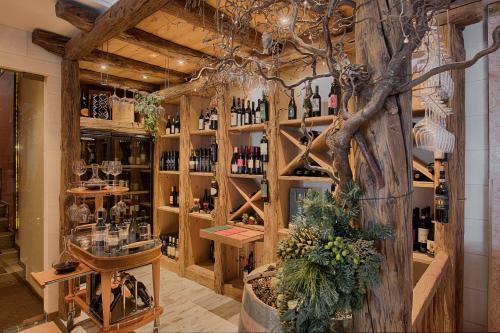a wine tasting room with a tree in the middle at Bellavista Relax Hotel in Levico Terme