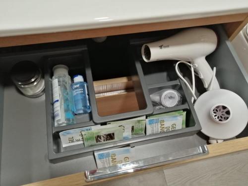 a shelf with hair products and a hair dryer at Alojamientos Tía María in Fernán Pérez