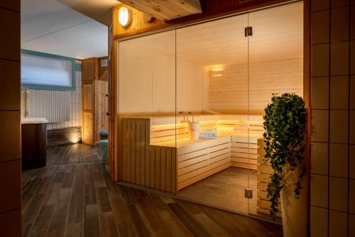 a bathroom with a tub and a sink at Hotel Cristallo in Bormio