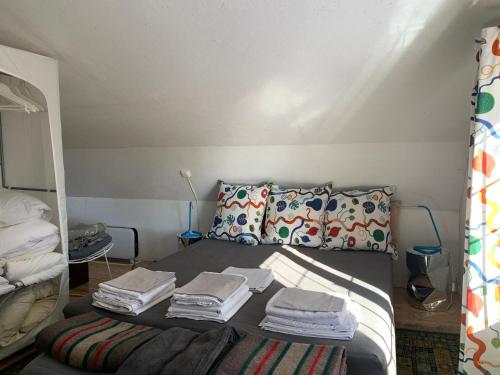 a bedroom with a bed with folded towels on it at Charmig stuga av rustik stil i Stockholms område in Stockholm