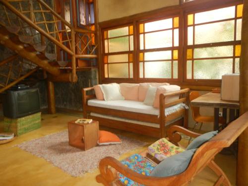 a living room with a couch and a table at Holiday home Ilhabela in Ilhabela