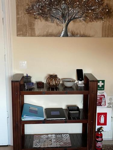 a shelf with various items on it in a room at The Odyssey Holiday Home - Agios Ioannis, Pelion in Agios Ioannis Pelio