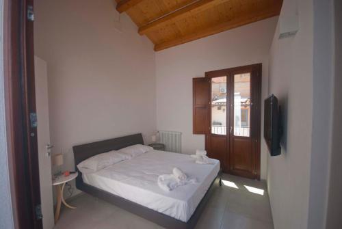 a bedroom with a bed with two towels on it at GIADA in Castellammare del Golfo