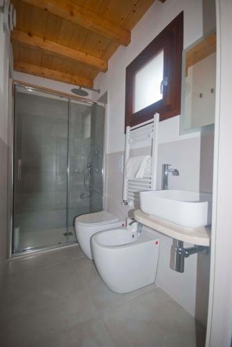 a bathroom with two sinks and a toilet and a shower at GIADA in Castellammare del Golfo