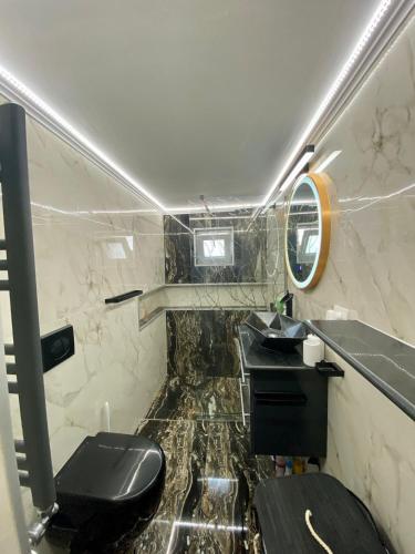 a bathroom with two sinks and a toilet at Casa Dutu in Tuzla
