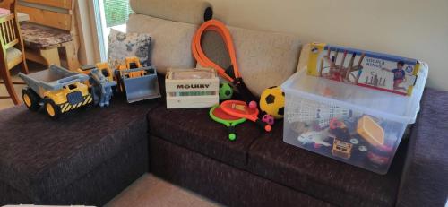 a living room with toys on a couch at Chata Mareček - v lesní osadě u řeky Lužnice in Skalice