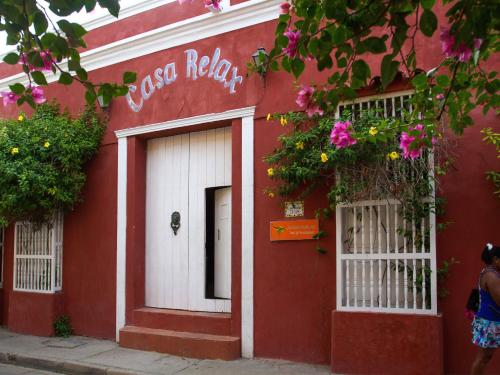 a red door leading to a building with a pink door at Casa Relax in Cartagena de Indias