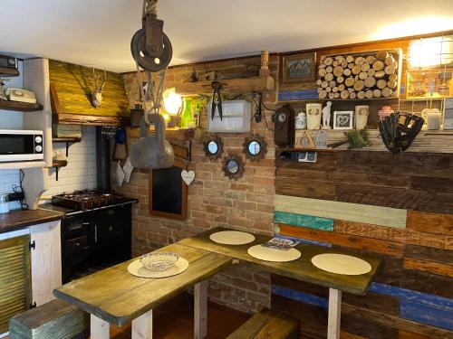 a kitchen with a wooden table with plates on it at Zielone Okiennice in Bachowice