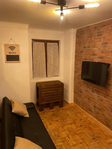 a living room with a couch and a flat screen tv at Apartamento Grace in Sintra