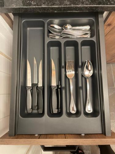 a tray with utensils sitting on a table at Apartamento Grace in Sintra