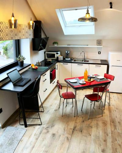 a kitchen with a table with a laptop on it at Gîte La Siroperie in Wanze