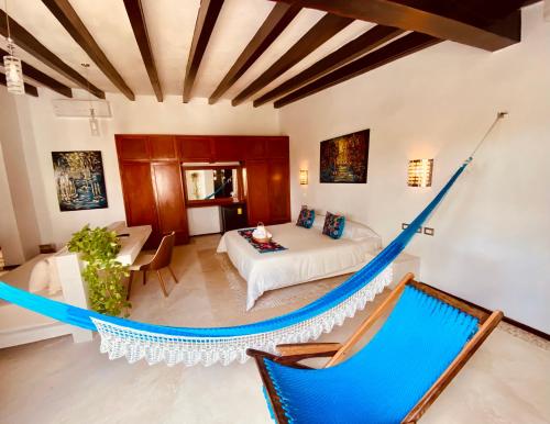 a living room filled with furniture and a large window at Hotel Para Ti - Adults Only in Holbox Island