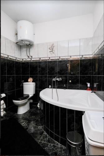 a bathroom with a tub and a toilet and a sink at Nera-etwa Konjic 1 apartment in Konjic