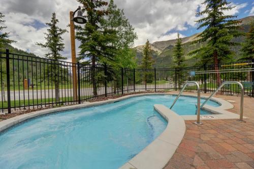 a swimming pool with a black fence at Cs302 Copper Springs Condo in Copper Mountain
