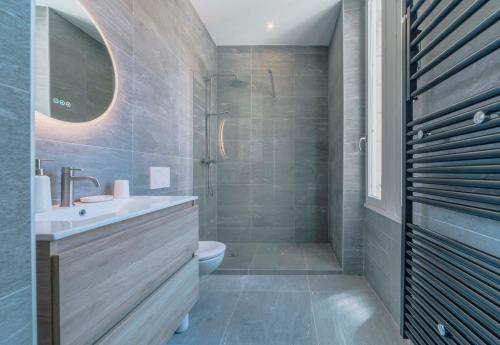 a bathroom with a sink and a toilet and a shower at Bakara, élégant t2 au cœur des Halles de Biarritz in Biarritz