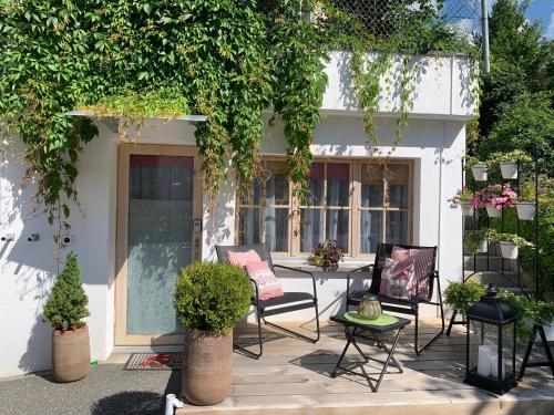 a patio with chairs and a table in front of a building at Chasa Bazzi in Scuol