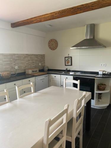 a kitchen with a large white table and chairs at Casa dos Avós in Póvoa de Lanhoso