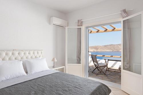 a bedroom with a bed and a view of the ocean at Estia's Residence in Mýkonos City