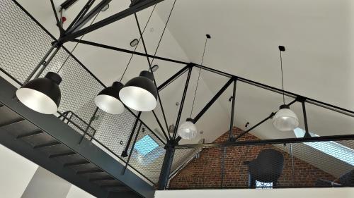 a group of lights hanging from a ceiling at Gîte La Siroperie in Wanze