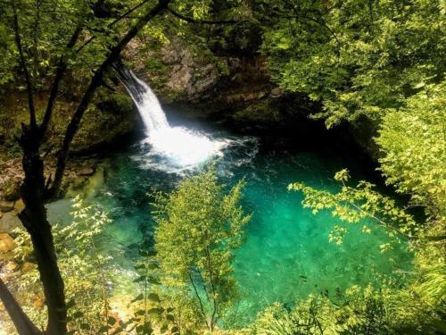 a waterfall in the middle of a river at Kulla e Sadri Lukes in Theth