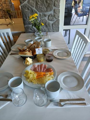 a table with a plate of food on it at Resort LUFT Sněžník in Sněžnik