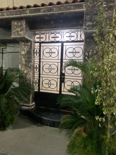 a black and white door in a building with plants at Paris st in Ismailia
