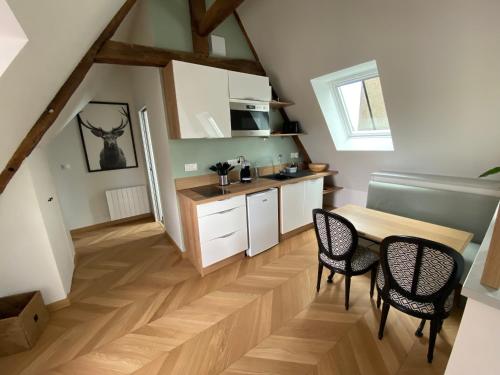 a kitchen with a table and chairs in a room at Studio centre ville in Dol-de-Bretagne
