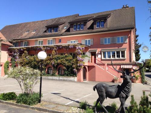 a statue of a deer in front of a building at Landhotel Hirschen in Trüllikon