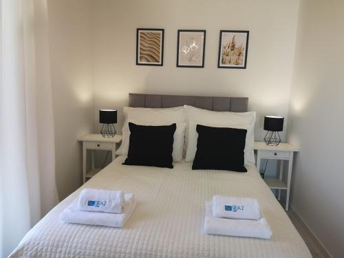 a bedroom with a bed with two towels on it at Sea2 in Nowęcin