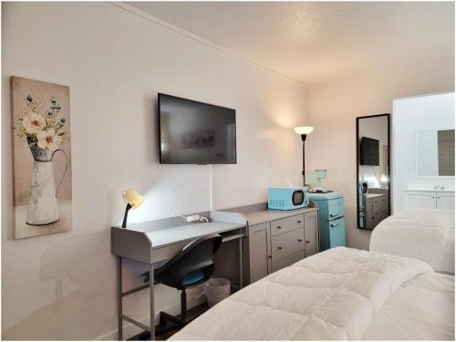 a hotel room with a bed and a desk and a bedroom at Buckley Inn in Buckley