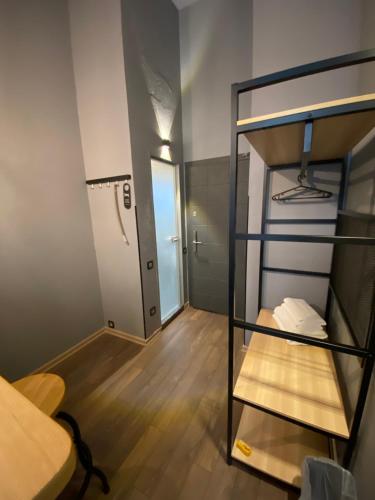 a small room with a bunk bed and a hallway at Lift Rooms - Derybasivska in Odesa