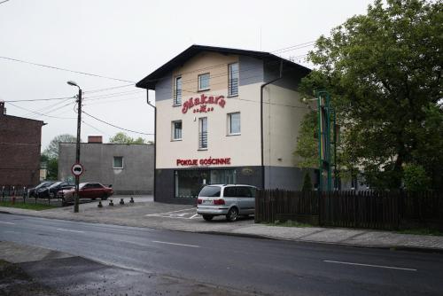 a car parked on the side of a road next to a building at Makara in Katowice