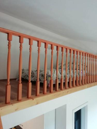 a staircase with wooden railings in a house at Deni09 in Pomer