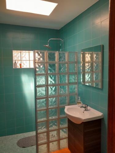 a bathroom with a sink and a glass wall at Nadadouro Eco-country-cottage in Nadadouro