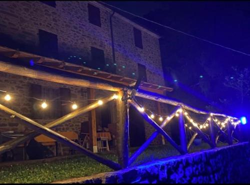 a building with lights on the side of it at night at Villa Terria in Bagni di Lucca