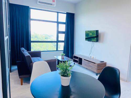 a living room with a blue table and chairs at KEEN Suites-Jesselton Quay in Kota Kinabalu