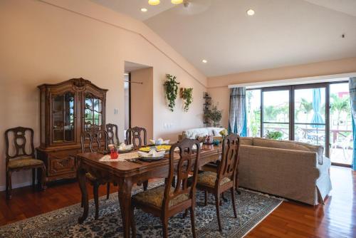 a living room with a table and a couch at Palm Villa Ishigakijima karei in Ishigaki Island