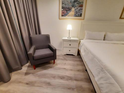 a bedroom with a bed and a chair at Stardust Hotel in Miami Beach