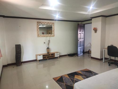 a room with a table and a mirror on the wall at BEA Privileged Apartment in Lamai