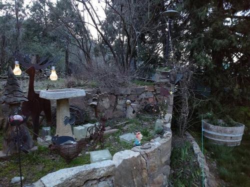a garden with a stone wall and a stone sink at O'Brien's Oasis in Miramonte
